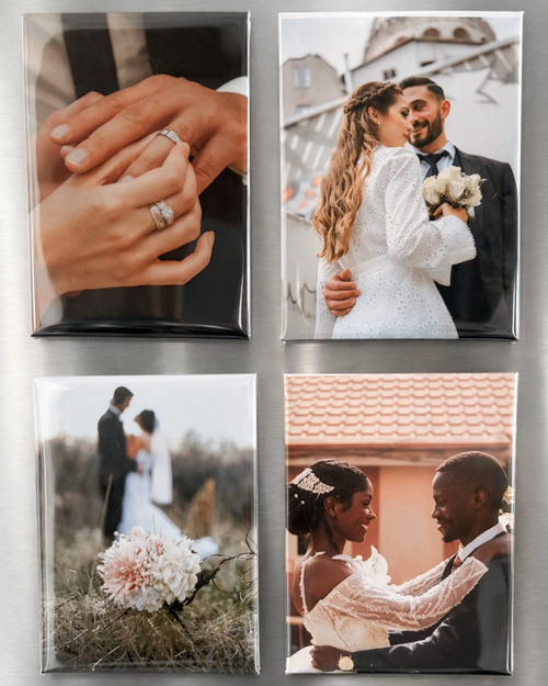 Four photo magnets of a couple on a fridge.
