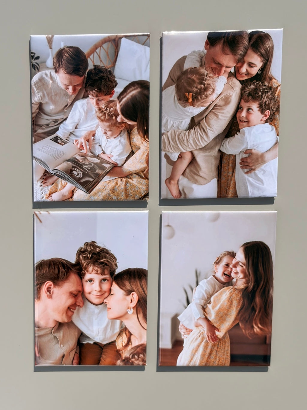 A four-panel custom photo collage print featuring family photographs, displayed on a light beige mat within a black frame.