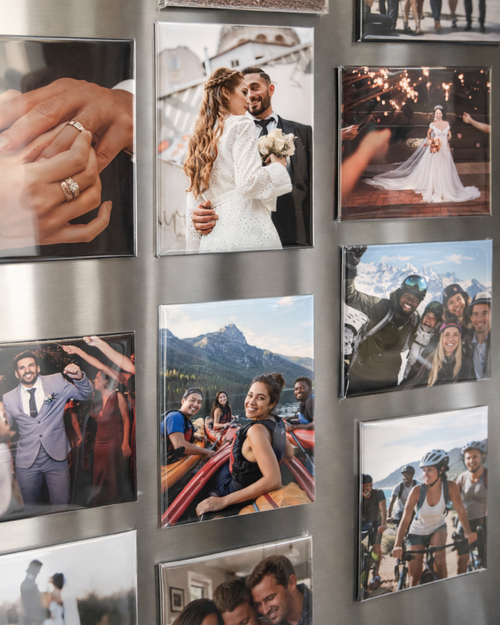 Collection of photo magnets on a metallic surface, including a couple, a wedding scene, and various other moments.